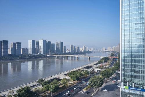 a view of a river in a city with buildings at The Westin Fuzhou Minjiang in Fuzhou