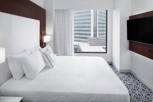 a hotel room with a large bed and a window at Residence Inn by Marriott Stamford Downtown in Stamford