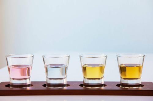 a group of four drinking glasses on a wooden tray at Residence Inn by Marriott Stamford Downtown in Stamford
