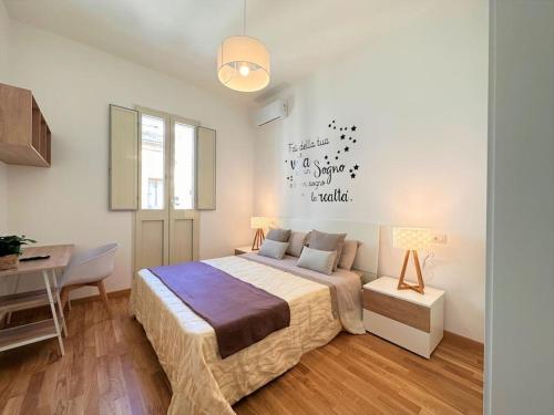 a bedroom with a bed and a table and a desk at Lella suite home in Lecce