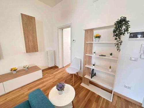 a living room with a blue couch and a table at Lella suite home in Lecce