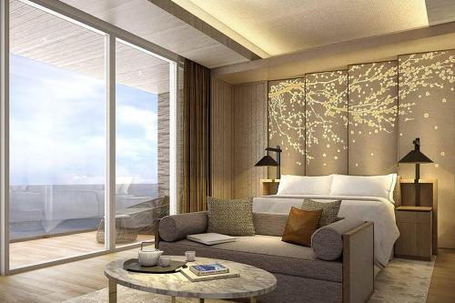 a bedroom with a bed and a couch and a table at Renaissance Suzhou Taihu Lake Hotel in Suzhou