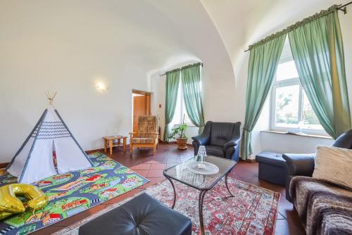 a living room with a couch and a table at Kaštieľ Sokoľany in Sokoľany