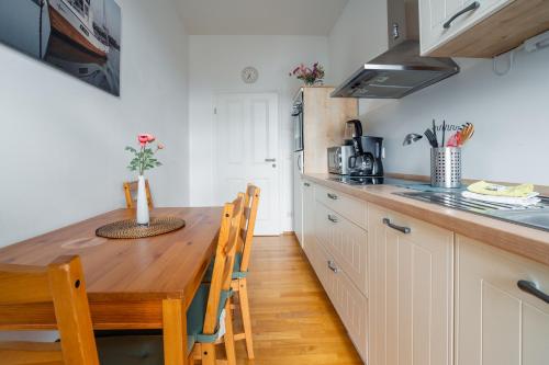 een keuken met een houten tafel en een aanrecht bij City Park Apartments - #16, #18 & D - Moderne Apartments & Suiten im Zentrum in Leipzig