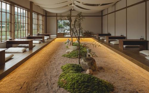 a large room with sheep sitting on a rug at Uon in Gyeongju