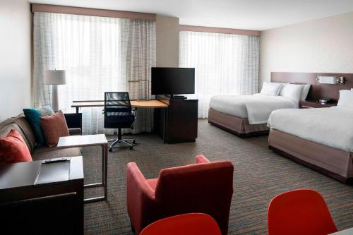 a hotel room with two beds and a tv at Residence Inn by Marriott Boston Watertown in Watertown