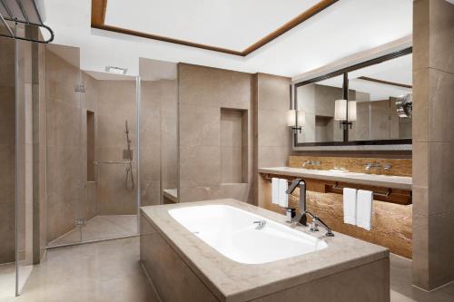 a bathroom with a sink and a shower at Sheraton Qiandao Lake Resort in Thousand Island Lake