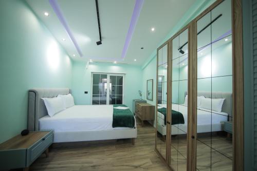 a bedroom with a white bed and a mirror at Smart Villa Olive 