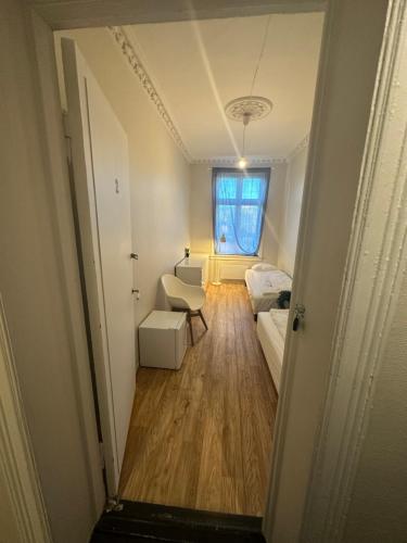 a hallway of a room with a bed and a couch at Center apartments in Oslo