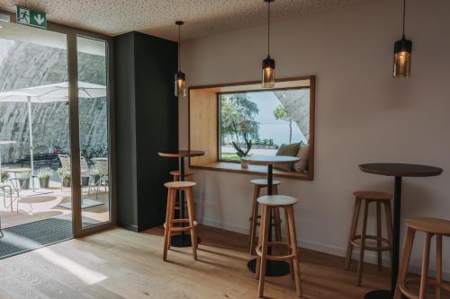 a bar with stools in a room with a window at Montreux Youth Hostel in Montreux