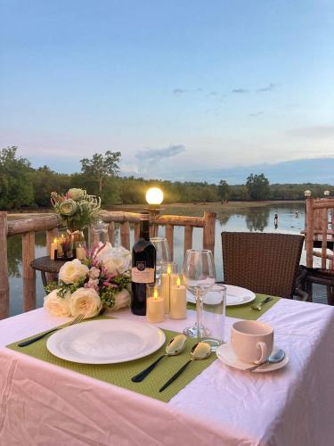a table with a white table cloth and a bottle of wine at Kaway Resort & Spa in Tabuelan