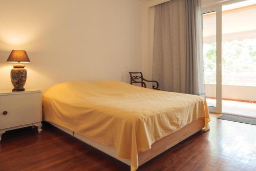 a bedroom with a bed with a yellow bedspread at Vrilissia cozy apartment in Athens