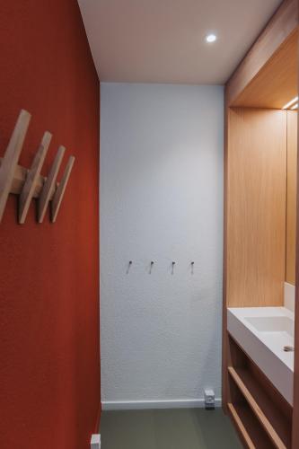 a bathroom with a white wall and a white sink at Montreux Youth Hostel in Montreux