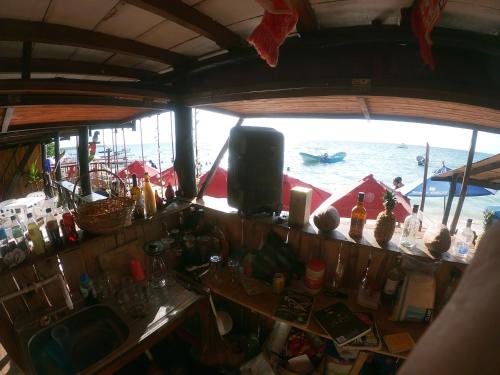 a bar on a boat with a view of the water at Ecohotelhector in Playa Blanca