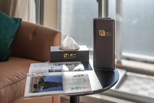 a table with a book and a box on it at Apartment Hotel 11 Shinsaibashi 2 in Osaka