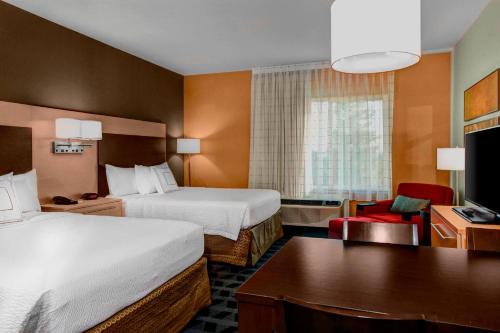 a hotel room with two beds and a desk at TownePlace Suites by Marriott Bakersfield West in Bakersfield