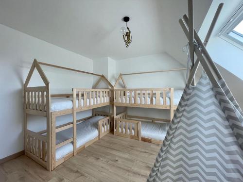 une chambre avec deux lits superposés et un plafond dans l'établissement Refuge côté Mer by Melrose, à Asnelles