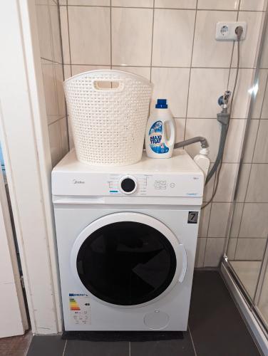 a washing machine with a basket on top of it at Spacious apartment in Asten perfect for long stays in Asten