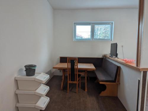 a room with a desk and a table with a computer at Spacious apartment in Asten perfect for long stays in Asten