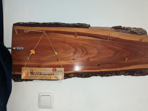 a wooden box with a sign hanging on a wall at Spacious apartment in Asten perfect for long stays in Asten
