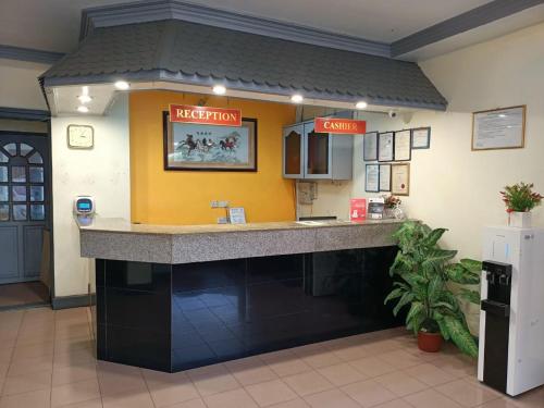 a fast food restaurant with a counter in a room at Monaco Hotel in Tawau