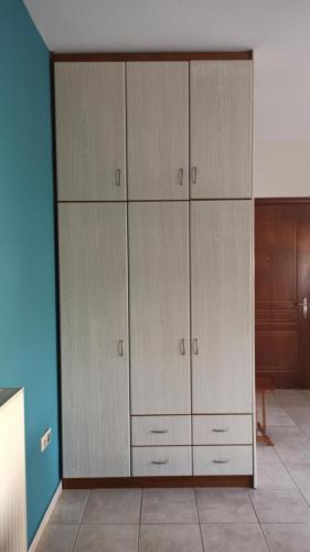 a large closet with white cabinets in a room at Litochoro apartment in Litochoro