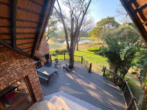 an overhead view of a wooden deck with benches at Kruger Park Lodge - Private Villa 514 in Hazyview