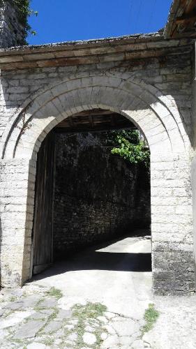 a stone archway in a brick wall with a tunnel at Konaku Guest house in Gjirokastër