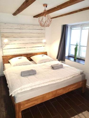 a bedroom with a large bed with two towels on it at Altstadt Apartment Kempten in Kempten