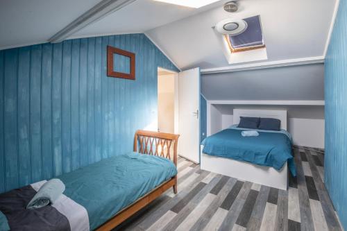 a small bedroom with two beds and a tv at La Champtocette de la Loire in Champtoceaux