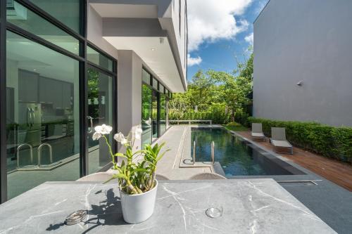 an external view of a house with a swimming pool at Villa Lami - Luxury 3-Bedroom Modern Villa in Phuket with Private Pool, Gym & Sauna in Phuket