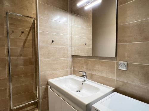 a bathroom with a sink and a shower at Joli T3 rénové ds une villa 1900 in Cauterets