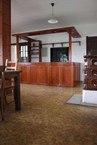 a large room with a table and wooden cabinets at Penzion Hodky in Světlá pod Ještědem