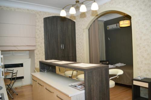 a kitchen with a counter and a table with chairs at Vachnadze Apartment in Tbilisi City