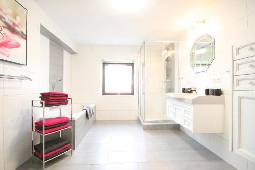 a white bathroom with a sink and a shower at Almliesl BREI-708 in Breitenbach am Inn