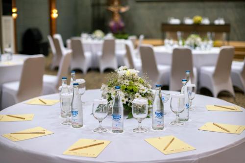 a table set up for a wedding with bottles and glasses at Grand Istana Rama Hotel in Kuta