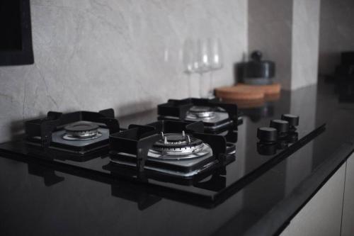 a counter with three stove top burners on it at Sewaro Homestay, 2BHK Suite in Āīzawl