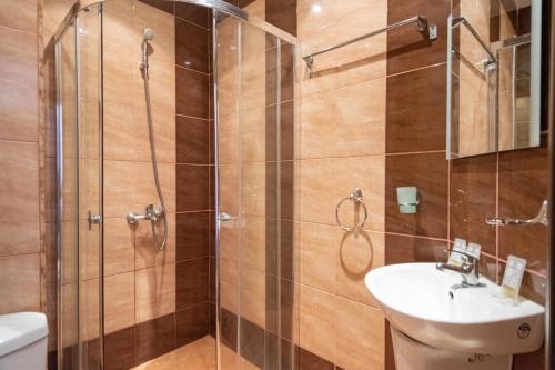 a bathroom with a shower and a sink at South Beach Hotel - New Management and Free Beach Access in Tsarevo