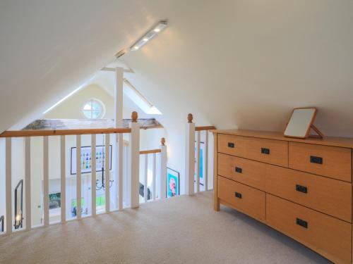 a room with a staircase and a dresser and a stair case at Pass the Keys Cosey 3 Sleeper Flat in Winkfield in Winkfield