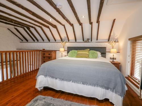 a bedroom with a large bed and two windows at The Weary Friar Inn in Pillaton