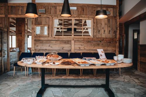a table with plates of food on top of it at CAPANNA PRESENA in Passo del Tonale