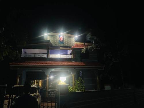a building with lights on top of it at night at Homestay near mangrove forest in Sānikatta