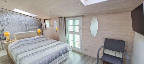 a bedroom with a bed and a surfboard on the wall at Charmante villa entièrement rénovée, dans le centre du village in La Couarde-sur-Mer