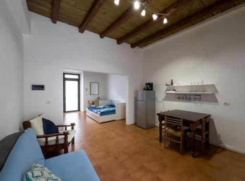 a large living room with a table and a kitchen at Host4All casa vacanze in Falconara Marittima