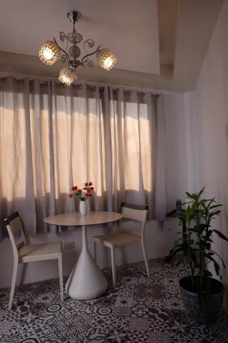 a dining room with a table and two chairs at Casa Dee Leticia in Sibalom