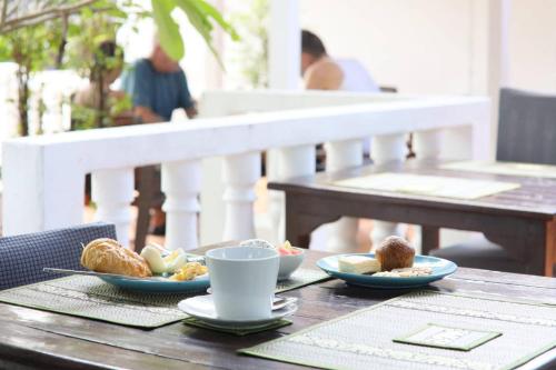 a table with plates of food and a cup of coffee at Keereeta Resort in Ko Chang