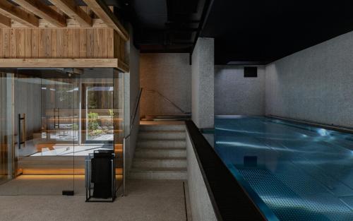 a swimming pool with a suitcase next to a building at Stary Niedźwiedź in Zakopane