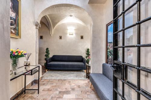 a living room with a couch and a window at Boutique Relais Barozzi & SPA in Rome