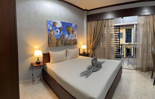 a bedroom with a large bed and two lamps at S a f e Residence Patong in Patong Beach