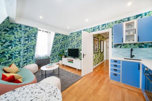 a living room with blue and green wallpaper at Crashpads Shoreditch Apartments - Brick Lane Mini Lofts in London